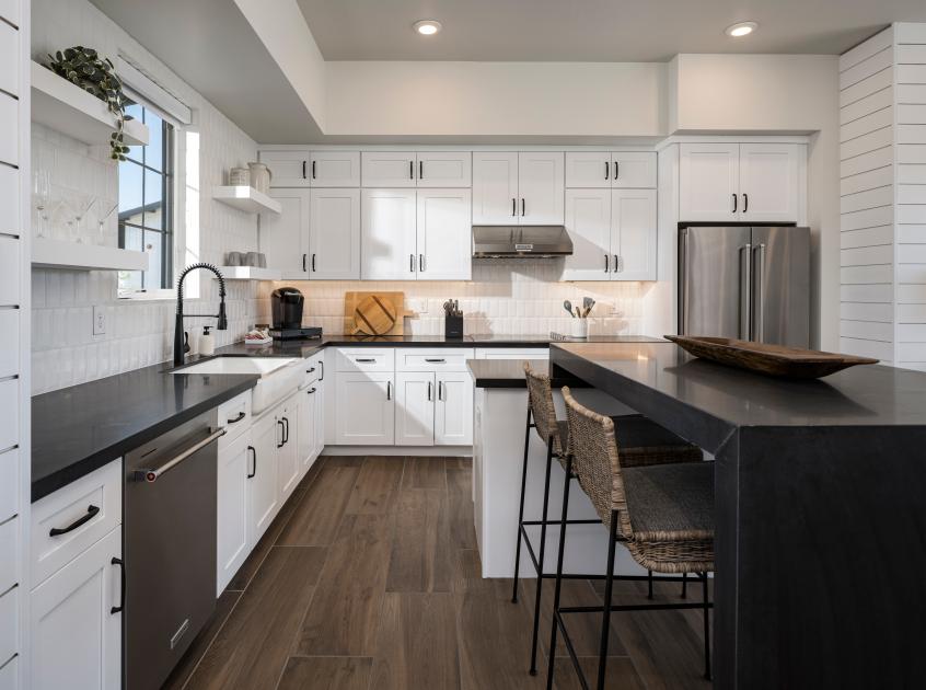 Beautiful kitchen with full-height tile backsplash and white shaker cabinets